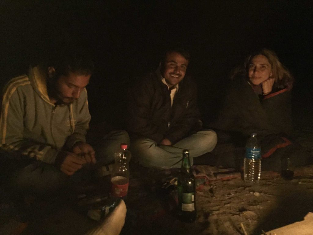 a group of people sitting on the ground of thar desert