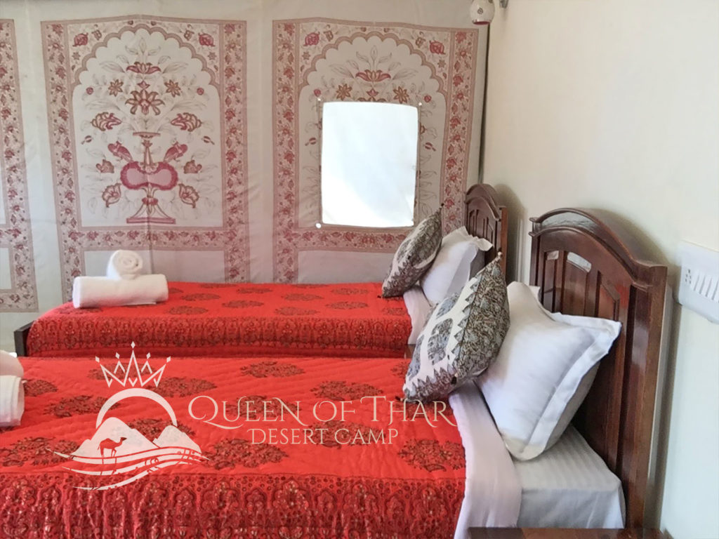 Thar bed with red bedspread and pillows