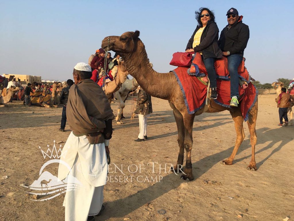 couple in riding a camel in that desert